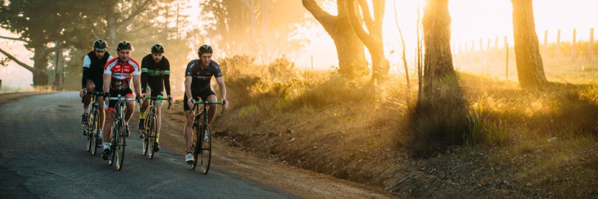 person in green jacket riding bike