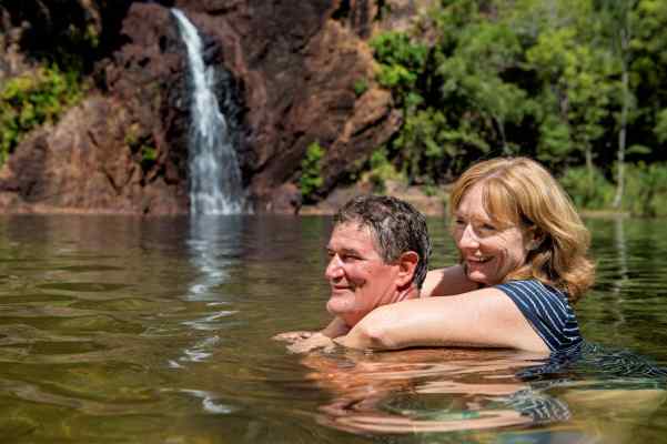 Couple enjoying a swim at a natural spring in the Northern Territory